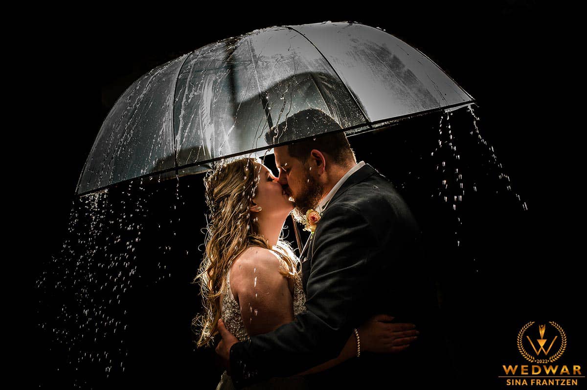 Küssendes Hochzeitspaar unterm Regenschirm. Hochzeitsfotografin Remscheid bildsprache Sina Frantzen